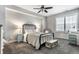 Bright bedroom featuring a black iron bed, plush carpet, and a desk area with ample natural light at 1401 Farmhouse Dr, Westfield, IN 46074