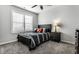 Comfortable bedroom featuring a bed with a dark headboard, plush carpet, and a window with plantation shutters at 1401 Farmhouse Dr, Westfield, IN 46074