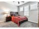 This cozy bedroom is painted with a light gray color and features shuttered windows and a wood-framed bed at 1401 Farmhouse Dr, Westfield, IN 46074