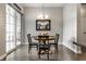 Dining area with wooden table, black chairs, and sliding glass doors leading to the outdoor space at 1401 Farmhouse Dr, Westfield, IN 46074