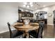 Cozy dining area with a wooden table, black chairs, and a kitchen view at 1401 Farmhouse Dr, Westfield, IN 46074