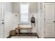 Bright foyer features paneled walls, wooden bench, stylish hooks, and a glimpse of wood flooring at 1401 Farmhouse Dr, Westfield, IN 46074