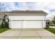 Two-car garage showcases white doors, exterior lighting, and a basketball hoop for outdoor fun at 1401 Farmhouse Dr, Westfield, IN 46074