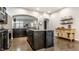 Open kitchen featuring dark cabinets, granite counters, stainless steel appliances, and a kitchen island with seating at 1401 Farmhouse Dr, Westfield, IN 46074