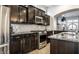 Stylish kitchen with dark cabinets, stainless steel appliances, granite countertops, and tile backsplash at 1401 Farmhouse Dr, Westfield, IN 46074