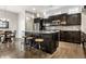 Modern kitchen with stainless steel appliances, dark cabinets, granite counters, and a large island with seating at 1401 Farmhouse Dr, Westfield, IN 46074