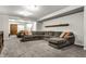 Cozy living room featuring a large sectional sofa, soft carpeting, and a decorative wooden beam at 1401 Farmhouse Dr, Westfield, IN 46074