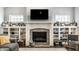 Beautiful fireplace with a brick surround and built-in bookshelves, perfect for cozy evenings at 1401 Farmhouse Dr, Westfield, IN 46074
