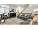 Relaxing living room with lots of natural light, modern staircase, and comfortable seating at 1401 Farmhouse Dr, Westfield, IN 46074