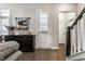 Cozy interior with modern staircase, sleek black cabinet, and lots of natural light from shuttered window at 1401 Farmhouse Dr, Westfield, IN 46074