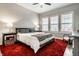 Cozy bedroom with neutral walls, shutters, a red rug and comfortable furnishings at 1401 Farmhouse Dr, Westfield, IN 46074