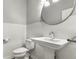 Modern powder room with pedestal sink, round mirror, and white subway tile backsplash at 1401 Farmhouse Dr, Westfield, IN 46074