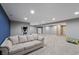 Finished basement featuring neutral decor, a comfortable couch and space for activities at 14059 Knightstown E Dr, Carmel, IN 46033