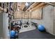 Basement gym with padded flooring, exposed ceiling, and exercise equipment, ready for workouts at 14059 Knightstown E Dr, Carmel, IN 46033