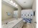 Bathroom featuring a double vanity and a shower-tub combo with a patterned curtain at 14059 Knightstown E Dr, Carmel, IN 46033