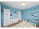 bedroom featuring blue accent wall and drawers for lots of storage space at 14059 Knightstown E Dr, Carmel, IN 46033