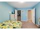 blue bedroom featuring a closet, white shelving, bed and playful decor at 14059 Knightstown E Dr, Carmel, IN 46033