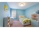 blue bedroom featuring a cozy bed, desk, and playful decor at 14059 Knightstown E Dr, Carmel, IN 46033