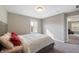 Neutral bedroom featuring a window with natural light and a comfortable-looking bed with red accent pillows at 14059 Knightstown E Dr, Carmel, IN 46033