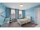 bedroom painted blue featuring two windows for lots of natural light and desk space at 14059 Knightstown E Dr, Carmel, IN 46033