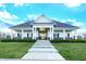 Exterior of a clubhouse with a gabled roof, white pillars, and manicured landscaping at 14059 Knightstown E Dr, Carmel, IN 46033
