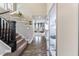 Inviting entryway with hardwood floors and a staircase leads to a bright, open living area at 14059 Knightstown E Dr, Carmel, IN 46033