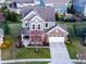 Well maintained two-story home with a brick and vinyl exterior, two car garage, and landscaped front yard at 14059 Knightstown E Dr, Carmel, IN 46033