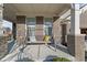 Inviting covered porch with a swing, brick pillars, concrete floor, and pillows for a comfortable seating area at 14059 Knightstown E Dr, Carmel, IN 46033