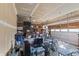 Cluttered garage showcasing potential storage space with overhead shelving and ample room for vehicles at 14059 Knightstown E Dr, Carmel, IN 46033