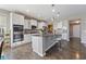 Well-appointed kitchen with stainless appliances, kitchen island with bar stool seating and pendant lighting at 14059 Knightstown E Dr, Carmel, IN 46033