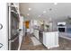 Bright kitchen with white cabinets, an island with seating, and stainless steel appliances for modern convenience at 14059 Knightstown E Dr, Carmel, IN 46033