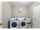 Laundry room with modern front-load washer and dryer, a sink, and ample space at 14059 Knightstown E Dr, Carmel, IN 46033