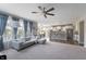 Open living space featuring plush seating, large windows with curtains, and seamless flow to the kitchen at 14059 Knightstown E Dr, Carmel, IN 46033