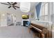 Cozy living room featuring a fireplace, piano, and an abundance of natural light from the large windows at 14059 Knightstown E Dr, Carmel, IN 46033