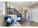 Cozy living room with hardwood floors, staircase, blue chairs, and white decor to create a modern interior at 14059 Knightstown E Dr, Carmel, IN 46033