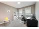 Well-lit home office with neutral walls, carpet, shelves, and a modern desk setup for productivity and style at 14059 Knightstown E Dr, Carmel, IN 46033