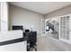Bright office featuring French doors, neutral walls, a modern desk, and a comfortable chair for working at home at 14059 Knightstown E Dr, Carmel, IN 46033