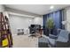 A cozy, carpeted office space with a desk, two monitors, a gray chair, and stylish decor at 14059 Knightstown E Dr, Carmel, IN 46033