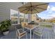 Back patio set up with outdoor table and chairs, an umbrella, and a grill, perfect for outdoor dining at 14059 Knightstown E Dr, Carmel, IN 46033