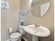 Stylish powder room with a pedestal sink, round mirror, soft towels, and minimalist decor for a modern touch at 14059 Knightstown E Dr, Carmel, IN 46033
