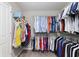 Walk-in closet with an organized shelving and hanging system, filled with clothes and accessories at 14059 Knightstown E Dr, Carmel, IN 46033