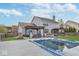 Spacious backyard showcasing a covered pool, patio, lush lawn, and mature trees at 1458 Longleaf St, Avon, IN 46123