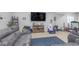 Finished basement area with a comfortable sofa, TV, and exercise equipment at 1458 Longleaf St, Avon, IN 46123