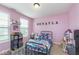 Cozy bedroom featuring pink walls, carpet, and a window for natural light at 1458 Longleaf St, Avon, IN 46123