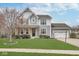 Charming two-story home featuring a well-manicured lawn, covered porch, and attached two car garage at 1458 Longleaf St, Avon, IN 46123