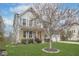 Attractive two-story home with a well-maintained lawn, covered porch, and tree in the front yard at 1458 Longleaf St, Avon, IN 46123