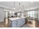 Open concept kitchen with island seating and view to living room with fireplace at 1458 Longleaf St, Avon, IN 46123