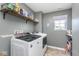 Laundry room featuring modern washer and dryer with a window and shelf storage at 1458 Longleaf St, Avon, IN 46123