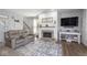 Comfortable living room features a stone fireplace, plush seating, and stylish decor at 1458 Longleaf St, Avon, IN 46123