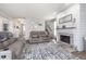 Open living space with stone fireplace, plush seating, and staircase at 1458 Longleaf St, Avon, IN 46123
